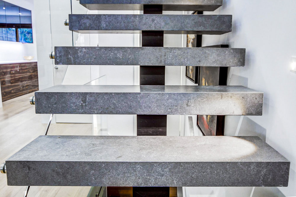 mono stringer stair / stone box steps / glass side mounted handrail / rectangular aluminum handrail