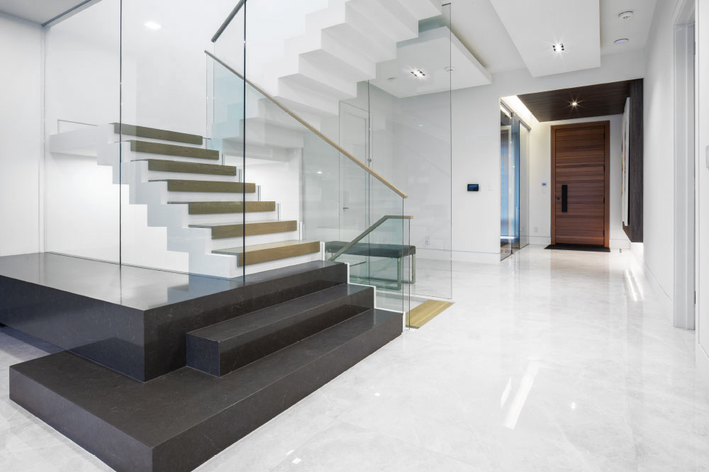 zig-zag stair / floor to ceiling glass / glass top mount handrails / rectangular wood handrails
